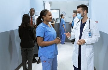 Hospital Employees Talking in a Hallway during Rounding